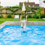 girl-jumps-into-the-pool